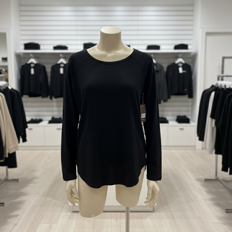 Black long-sleeve top on a mannequin in a clothing store setting