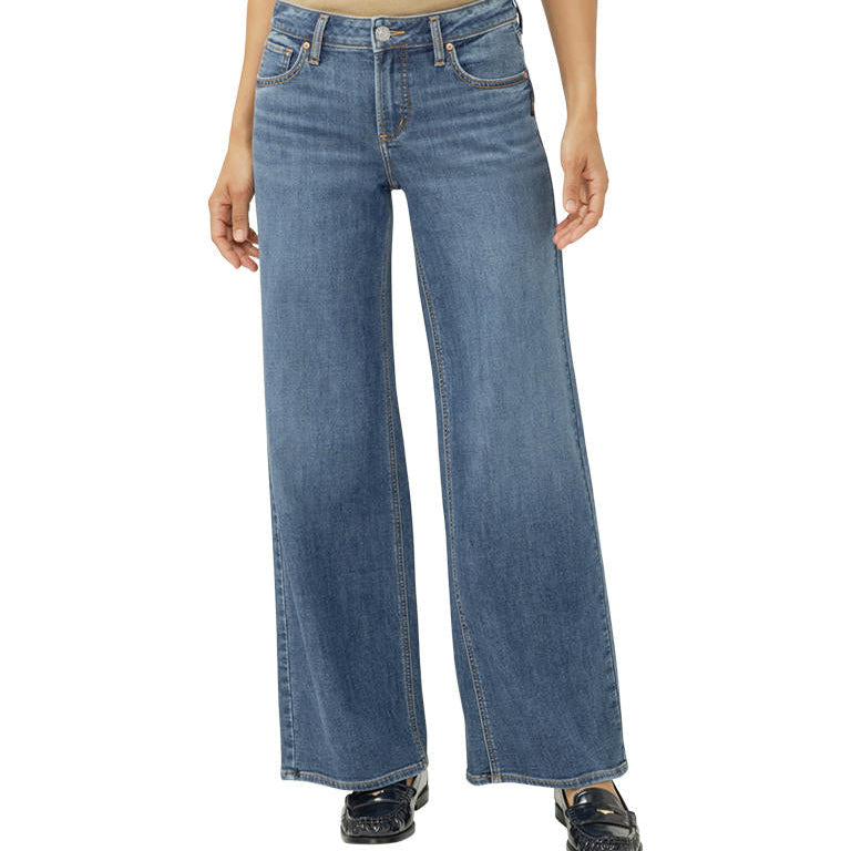 Blue jeans worn by a person on a white background