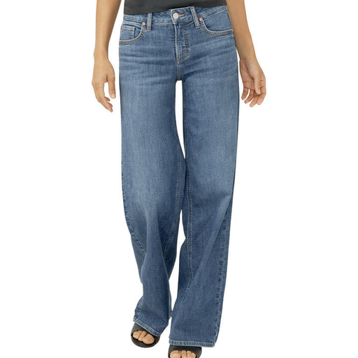 Blue jeans worn by a person on a white background