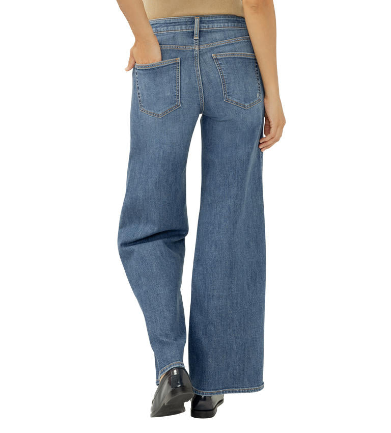 Blue jeans worn by a person on a white background