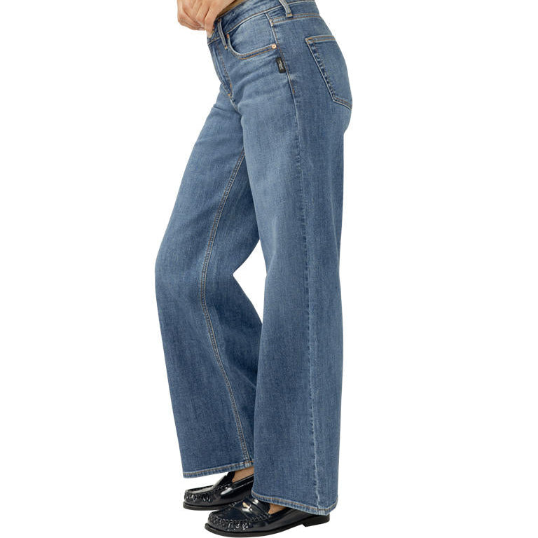Blue jeans worn by a person on a white background